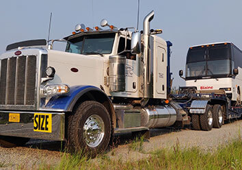 Ben's Towing truck towns motorcoach down Alaskan highway.